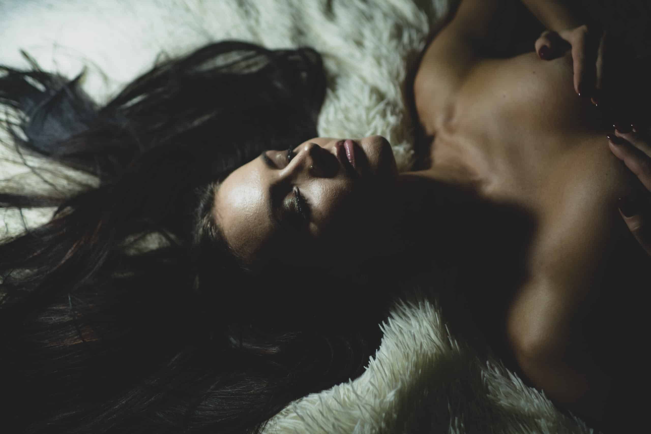 Sexy woman relaxing on fluffy bed. Female breasts smooth skin. Sexy girl sexual stimulation nipples. Erotic massage. Perfect breasts. Waiting for you. Orgasm and foreplay. Sexy attractive seductress.